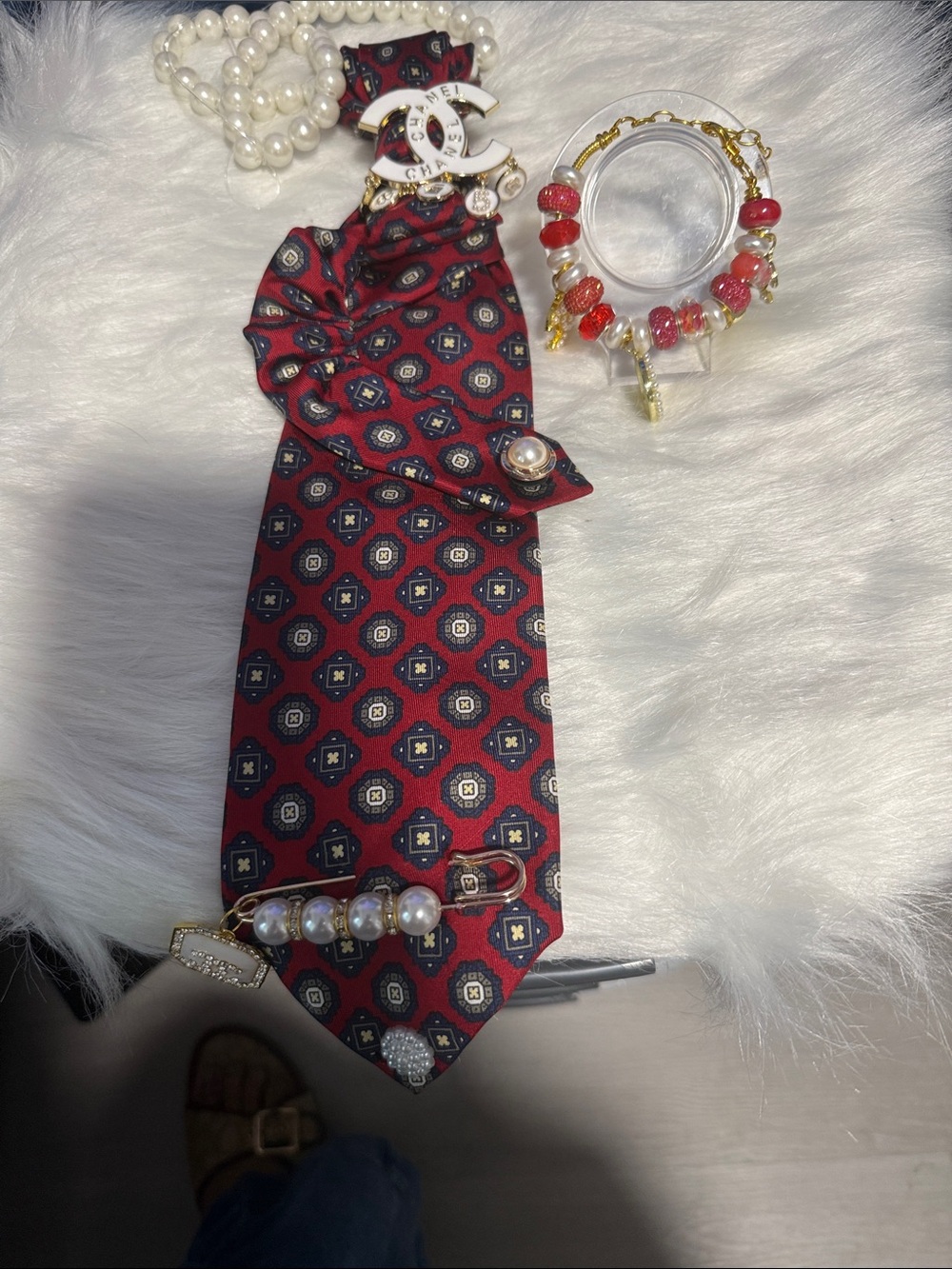 Junk Ties with white pearls and Chanel brooch and bracelet Chanel red and white